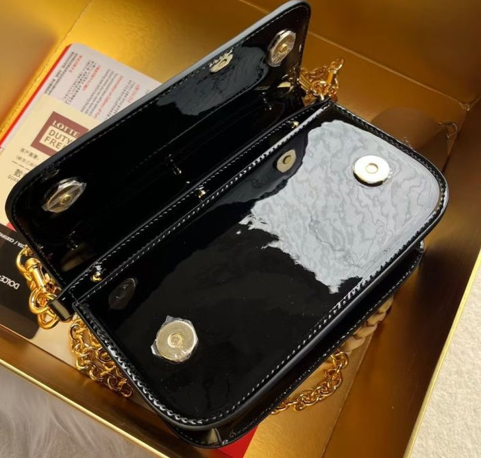 Dolce & Gabbana Shoulder bag in Black patent leather with a Gold Chain DG logo
