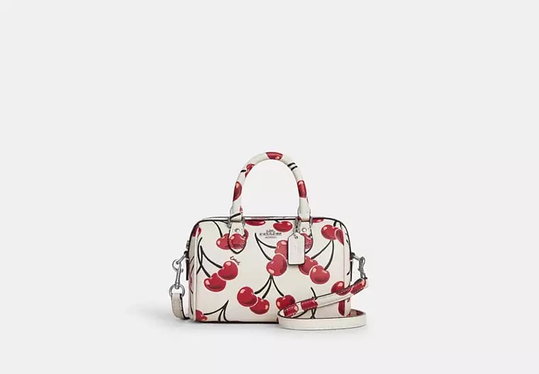 Coach Mini Rowan Crossbody 20 cm white with a cherry print.